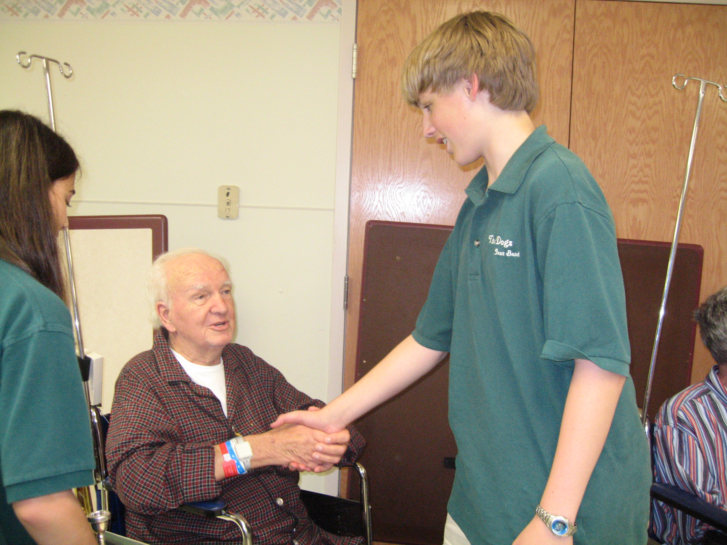 David shaking hands with a Veteran (Veterans' Memorial Hospital)